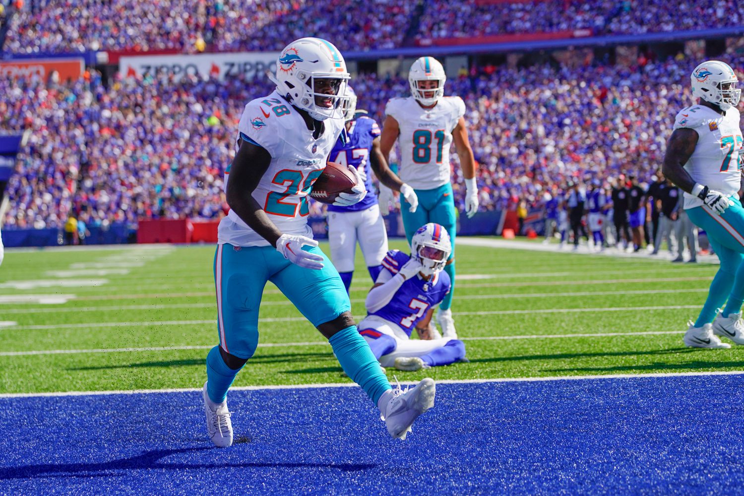 Miami Dolphins running back De'Von Achane (No. 28) rushes in for a touchdown against the Buffalo Bills at Highmark Stadium in Orchard Park, N.Y.
